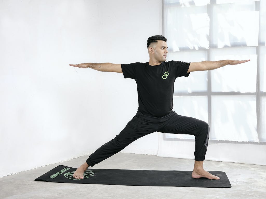 Warrior Pose 2 is a yoga pose that helps treat Parkinson's disease